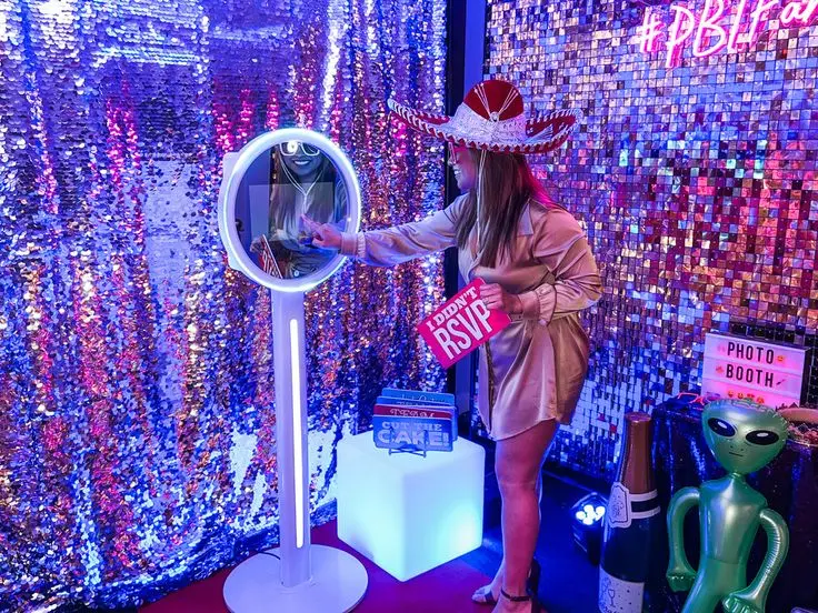 Guests posing with props in a Winter Park photo booth