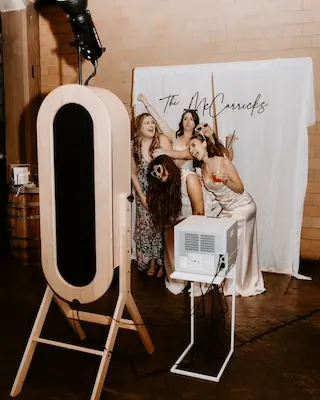 Guest receiving a printed photo tile with grid coordinates at a Miami event
