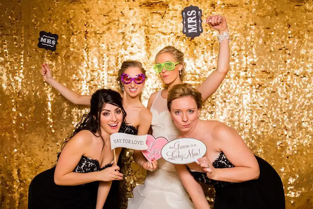 Guests using a photo booth at a Winter Park wedding reception